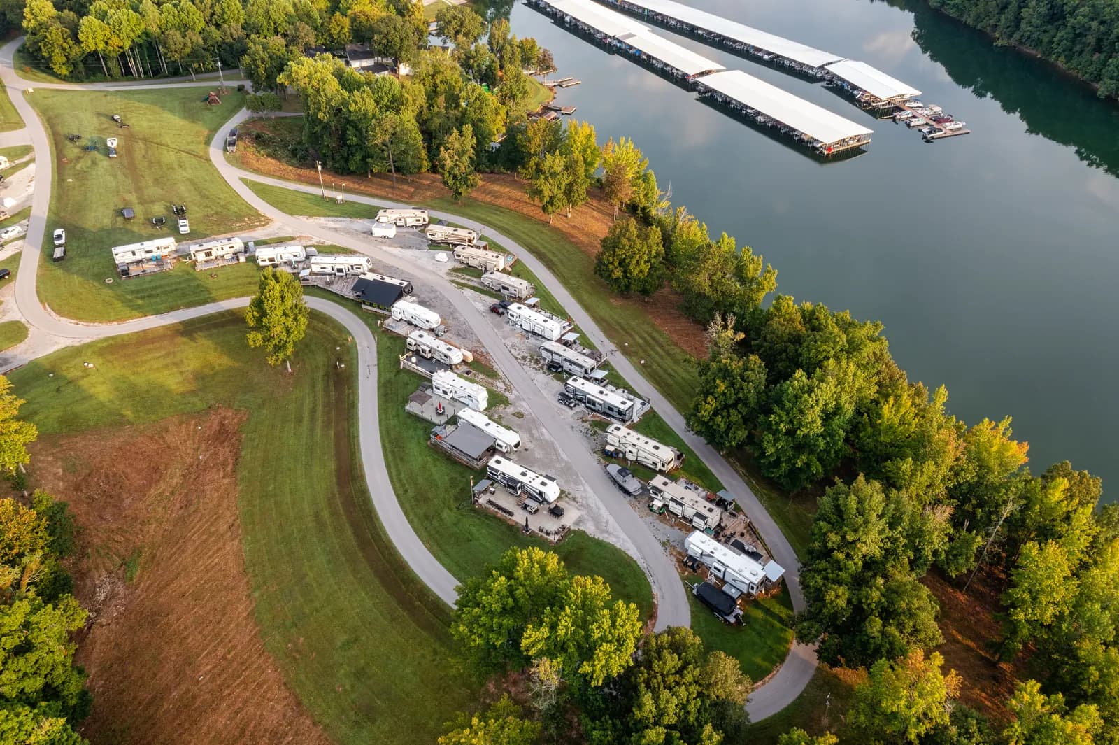 Aerial view of a lakeside RV park at golden hour