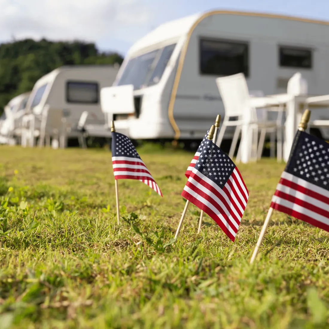 American flags decorating an RV campsite at sunset, evoking patriotic spirit at a public park