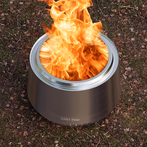 A fire pit on the ground, surrounded by stones