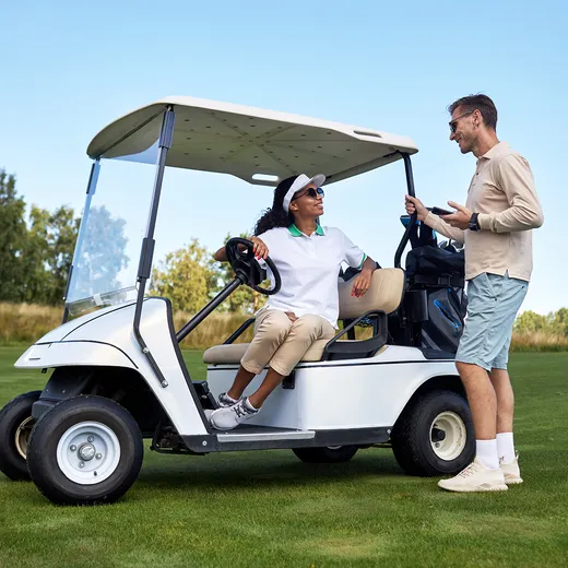 Guests with a golf cart on the course